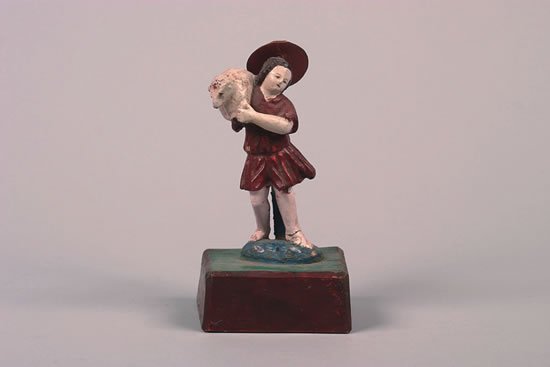 An Ecuadorian Polychrome Painted and Carved Wood: holding a lamb.Height 9 1/8 inches.