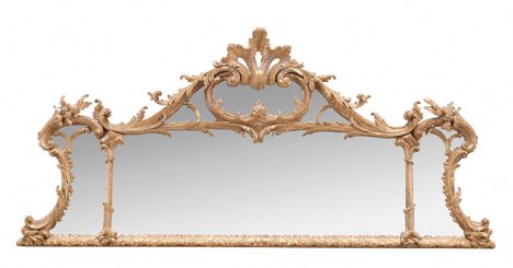 GEORGE III-STYLE CARVED GILTWOOD OVERMANTEL MIRROR: GEORGE III-STYLE CARVED GILTWOOD OVERMANTEL MIRROR 19th c. In the manner Thomas Chippendale, the divided shaped mirror plate within an ornate foliate and rococo scroll frame surmounted by a shell. H: