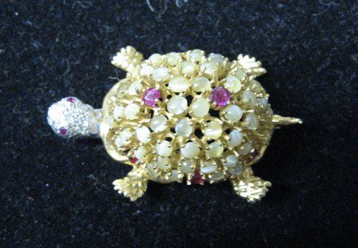 Ruby and diamond Turtle" pin, c. 1950, 18 Karat w: Ruby and diamond Turtle" pin c. 1950 18 Karat white and yellow gold miniature "Turtle" pin with a diamond encrusted head and set rubies in the shell. L: 1 1/2 in. L: 1 1/3 in. "