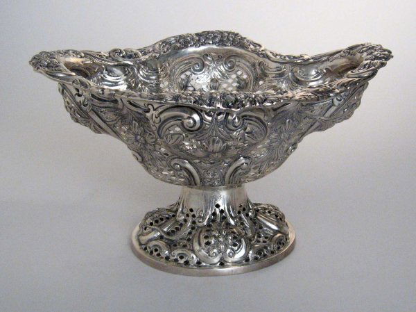 Victorian sterling silver pierced bowl, charles s: Victorian sterling silver pierced bowl charles stuart harris, london 1890 The lobed shaped oval openwork sides with foliate repousse decoration, raised on a conforming oval foot. H: 6 3/4, W: 12 in. 2