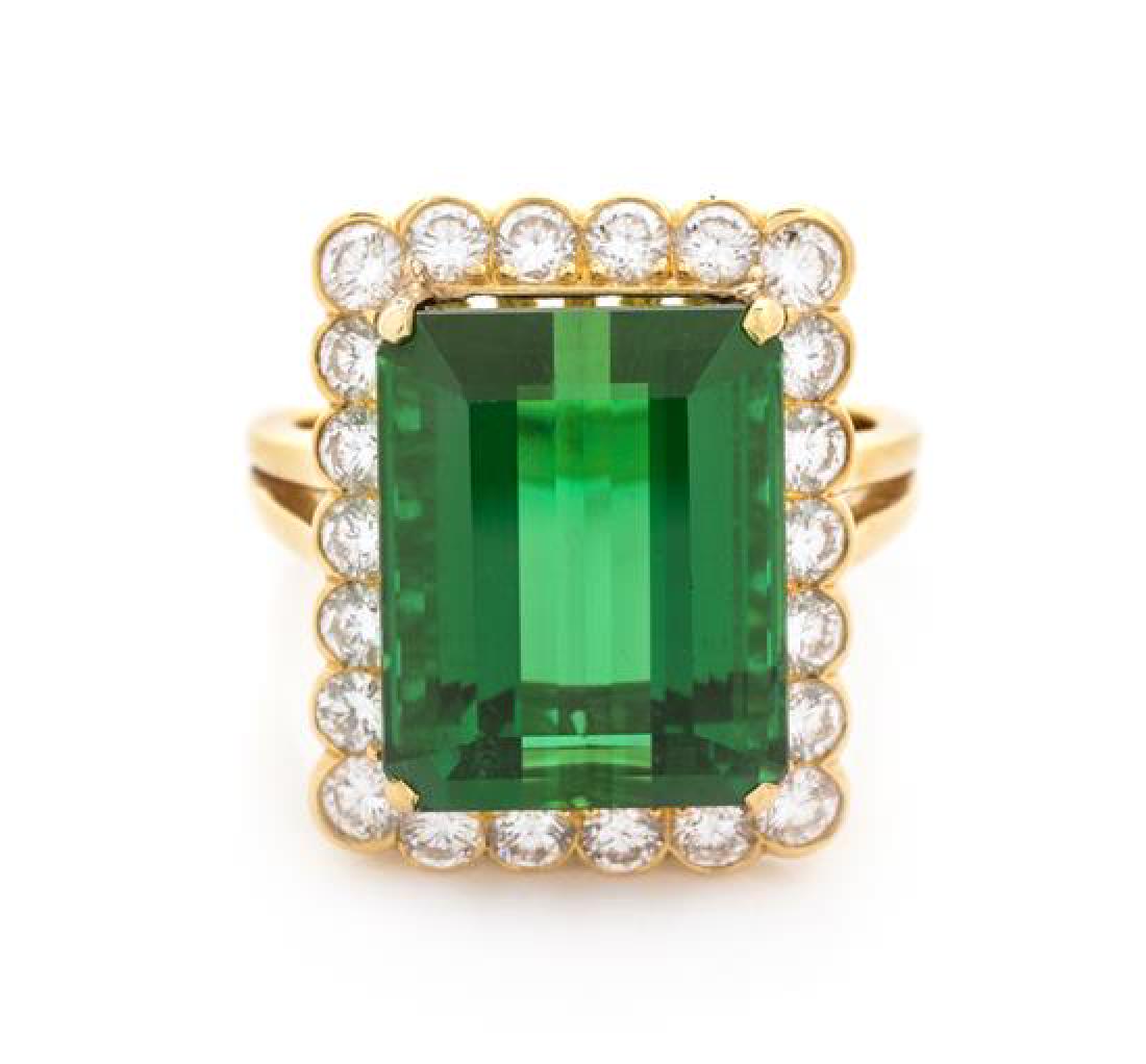 * An 18 Karat Yellow Gold, Green Tourmaline and Diamond: * An 18 Karat Yellow Gold, Green Tourmaline and Diamond Ring, McTeigue, containing one octagonal step cut green tourmaline measuring approximately 15.80 x 12.69 x 8.41 mm and 22 round brilliant cut di