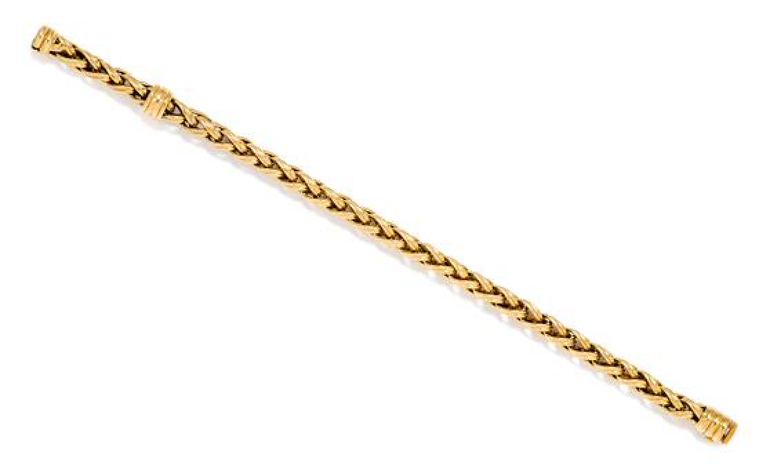 An 18 Karat Yellow Gold Wheat Link Chain Bracelet,: An 18 Karat Yellow Gold Wheat Link Chain Bracelet, Chimento, measuring approximately 5.00 mm wide. Stamp: CHIMENTO MODDEP. (Italian hallmarks) 750. 11.50 dwts. Estimate $ 400-600 The bracelet measures
