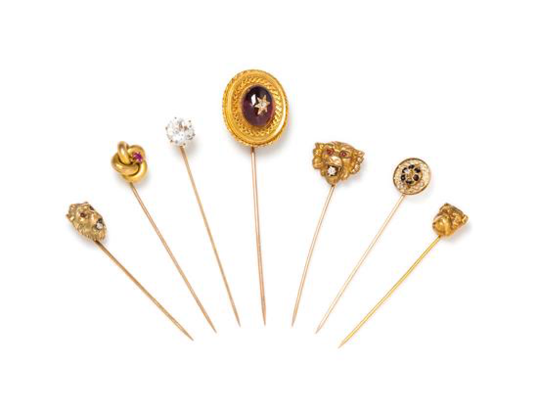 A Collection of Yellow Gold and Multigem Stickpins,: A Collection of Yellow Gold and Multigem Stickpins, consisting of a 14 karat yellow gold lion motif stickpin containing one old European cut diamond and two cabochon cut red paste stones, a 10 karat y