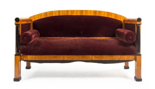 * A Biedermeier Parcel Ebonized Birch Sofa Height 39 x: * A Biedermeier Parcel Ebonized Birch Sofa manner of josef danhauser, mid-19th century the curved crest rail above the padded back, sides and stuffover seat with two bolster cushions, raised on square