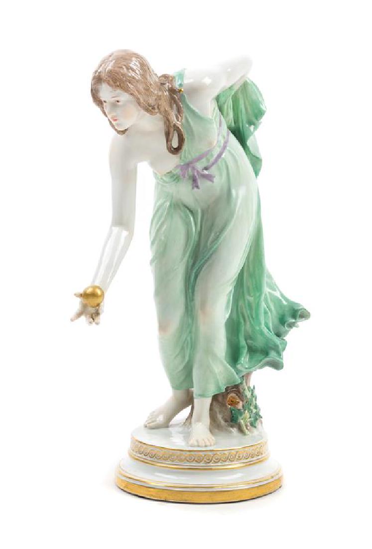 A Meissen Porcelain Figure Height 11 5/8 inches.: A Meissen Porcelain Figure modeled by walter schott (1861-1938) Kugelspielerin, with crossed swords in underglaze blue, incised Q180 and impressed 58 to the underside. Height 11 5/8 inches. Estimate $