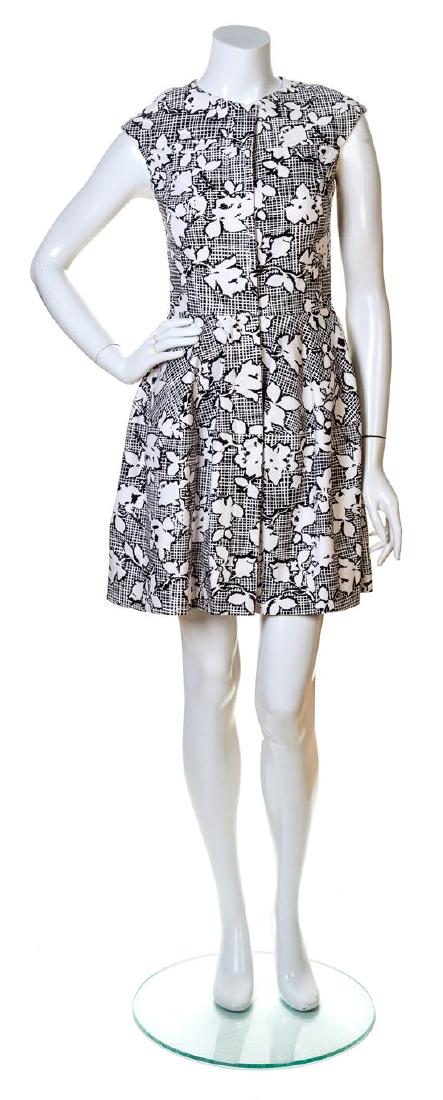 An Oscar de la Renta Black and White Cotton Print: An Oscar de la Renta Black and White Cotton Print Dress, with a rounded neck, cap sleeves, slip pockets, a front zip closure and a full skirt. Labeled: Oscar de la Renta. Size 4. Estimate $ 200-300 Ov