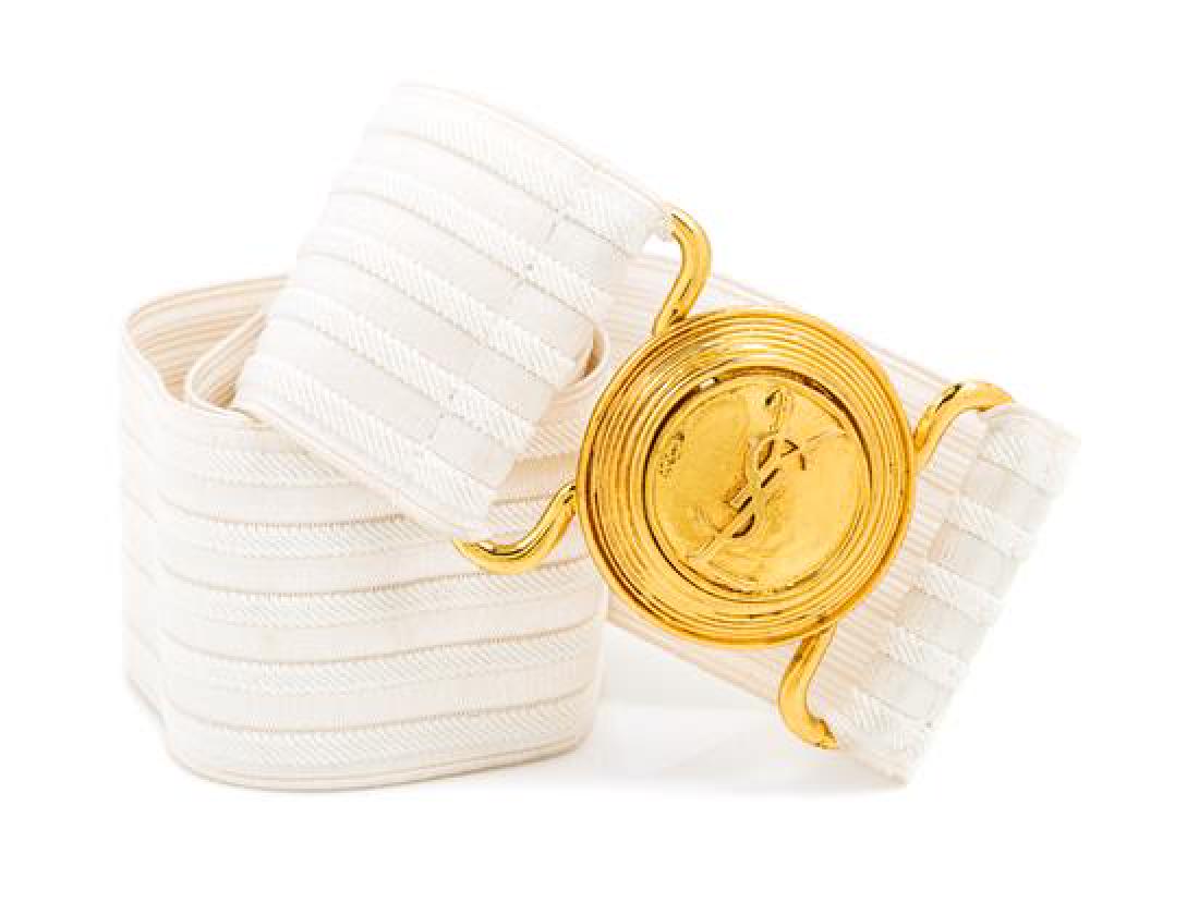 An Yves Saint Laurent White Stretch Belt,: * An Yves Saint Laurent White Stretch Belt, with a goldtone logo clasp. Stamped: Yves Saint Laurent. 34" x 2.25". Estimate $ 80-120 Property from the Estate of Mrs. Shirley Gibson, Glendale, Missouri 