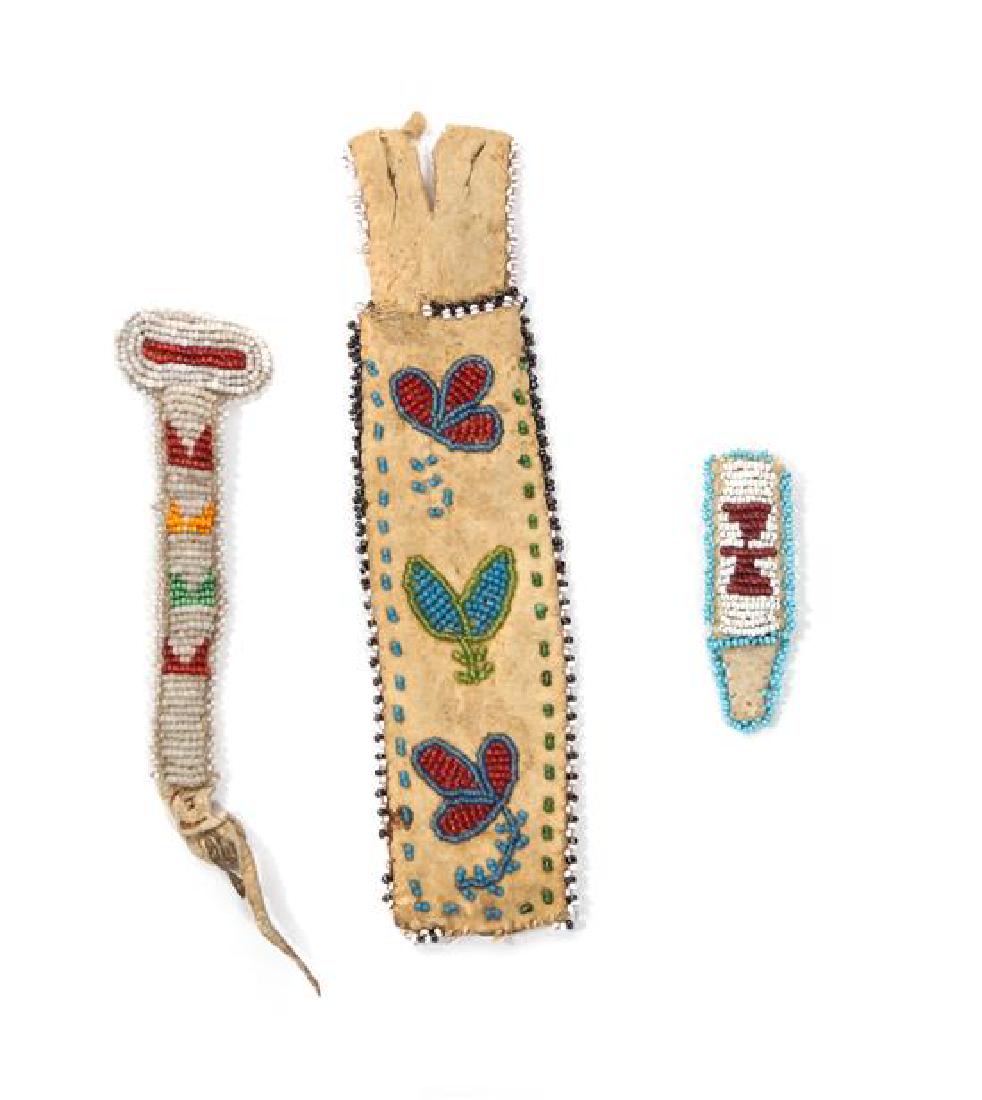Three Plains/Plateau Area Beaded Items Length of: Three Plains/Plateau Area Beaded Items comprising an awl case and two needle cases on buckskin Length of longest 8 inches Estimate $ 150-250