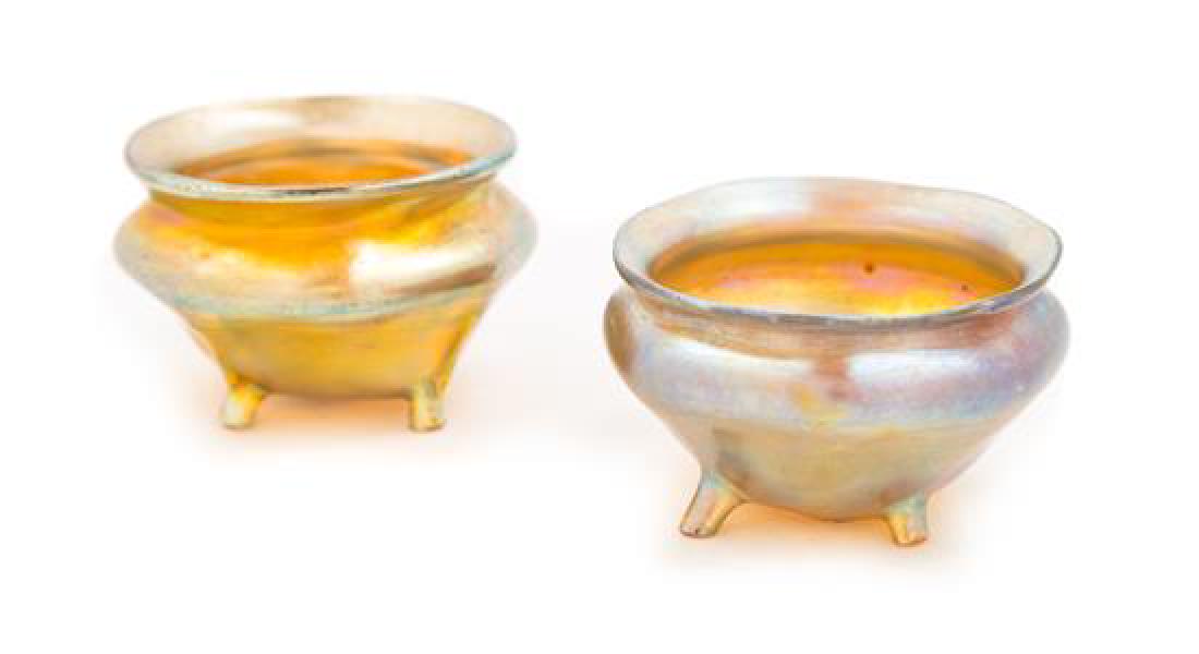 Tiffany Studios, EARLY 20TH CENTURY, two Favrile glass: Tiffany Studios EARLY 20TH CENTURY two Favrile glass footed salts, with gold iridescence signed L.C.T. Diameter 2 1/4 inches Estimate $ 200-400