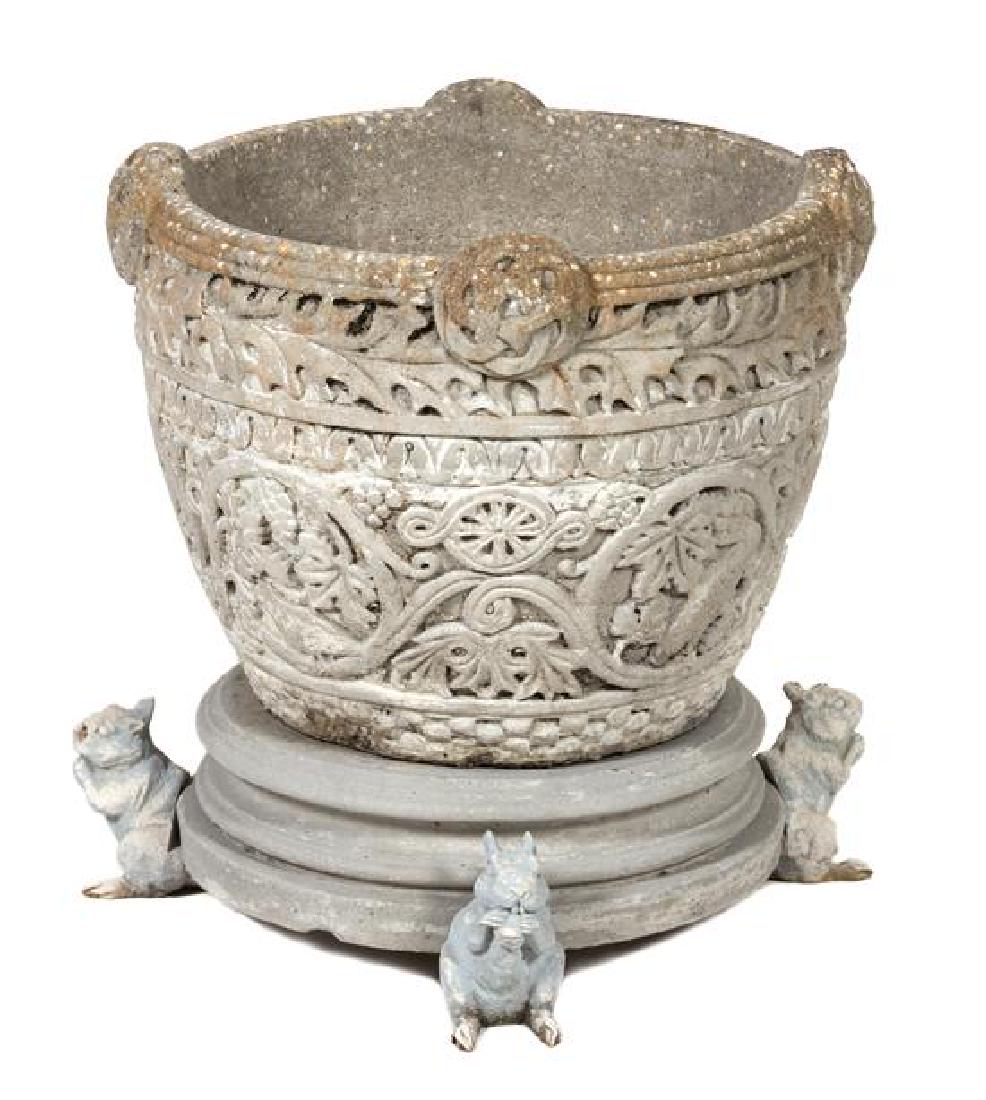 A Poured Cement Garden Pot Height 15 1/2 x diameter 20: A Poured Cement Garden Pot with foliate and Celtic knot decoration. Height 15 1/2 x diameter 20 inches. Estimate $100-200 Two feet broken off from squirels at base, coppering to pot, condition commens