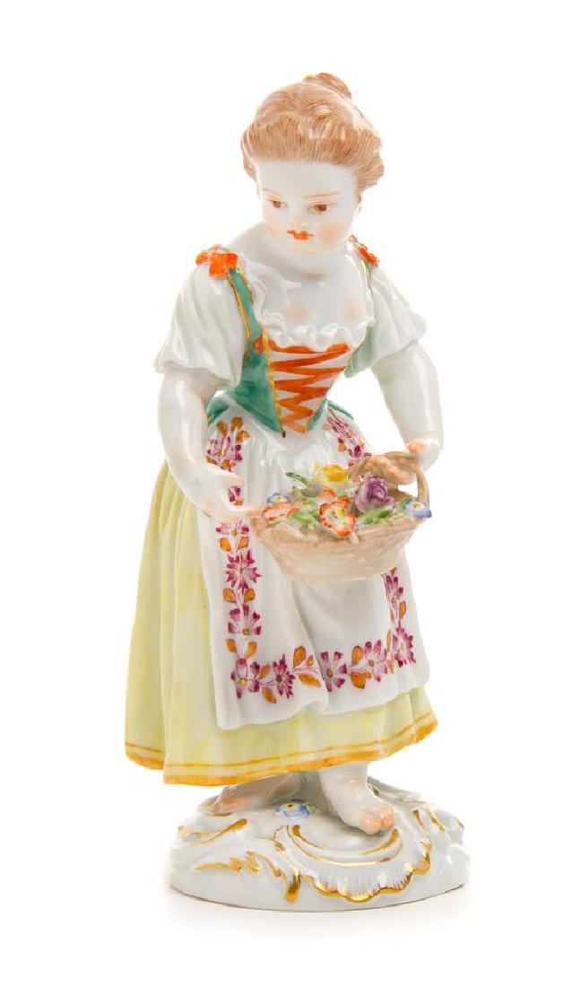 * A Meissen Porcelain Figure Height 5 1/4 inches.: * A Meissen Porcelain Figure late 19th/early 20th century Girl With Flower Basket, modeled after Johann Joachim Kaendler, incised 5, impressed 100 and with crossed swords in underglaze blue to the und