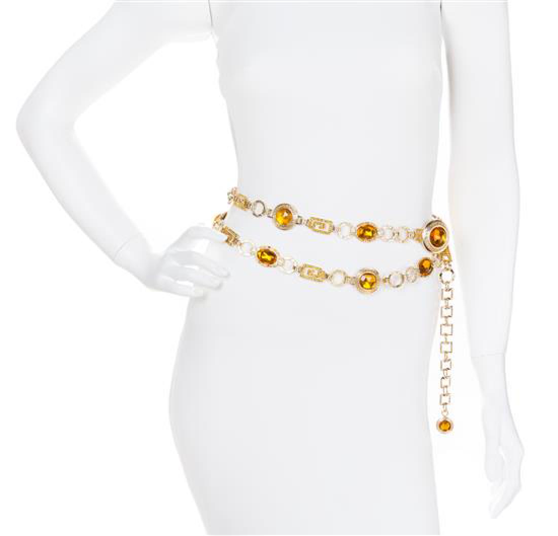 A Gianni Versace Amber Medallion and Rhinestone Greco: A Gianni Versace Amber Medallion and Rhinestone Greco Link Belt, 1990s, goldtone with oval snd round faceted stone medallions and an adjustable hook closure. Stamped: Gianni Versace. Length: 61"- 66".