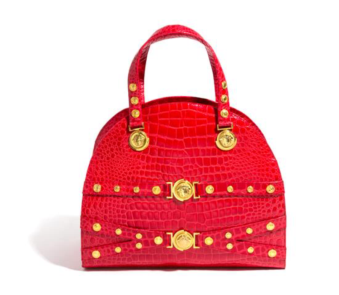 A Gianni Versace Red Croc Embossed Oversized Medusa: A Gianni Versace Red Croc Embossed Oversized Medusa Bag, Autumn/Winter 1994-1995, with decorative goldtone hardware, dual handles, a top zip closure and an interior zip pocket. Design featured on the