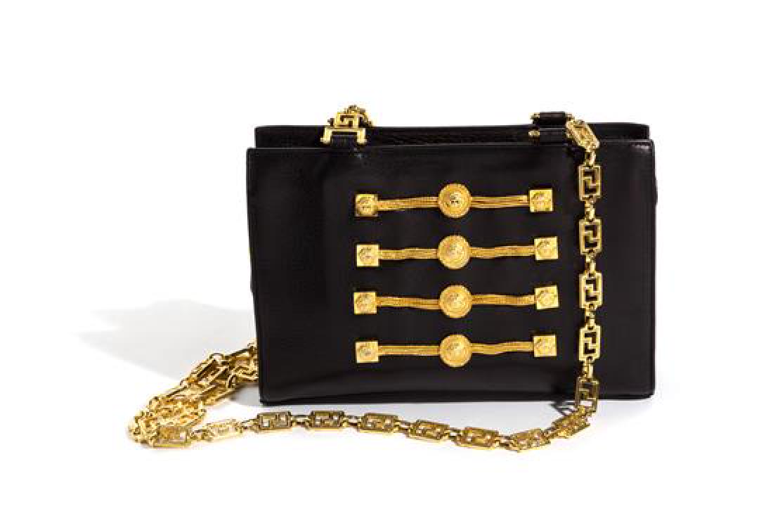A Gianni Versace Black Leather Chain Shoulder Bag,: A Gianni Versace Black Leather Chain Shoulder Bag, Autumn/Winter 1993-1994, with goldtone hardware, dual greco link chain straps, an embellished chain and Medusa medallion front, a top zip closure and