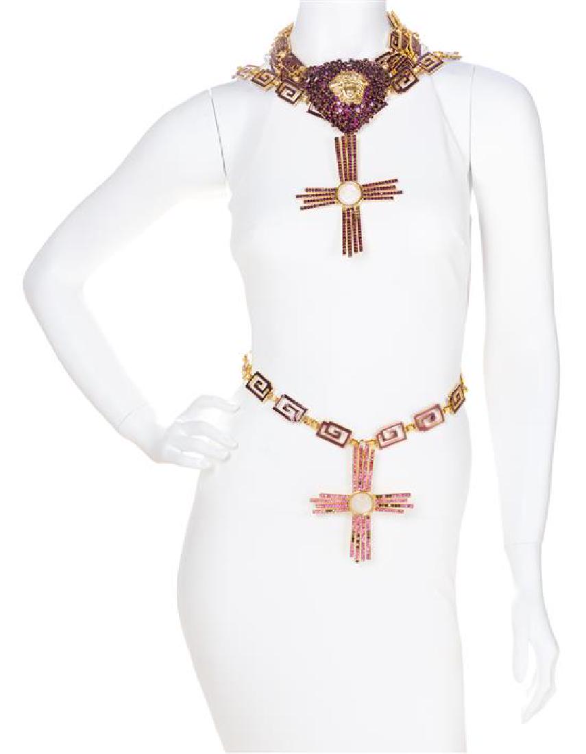 A Gianni Versace Purple Rhinestone Heart Choker and: A Gianni Versace Purple Rhinestone Heart Choker and Chain Belt, 1990s, goldtone with a four strand purple greco link choker with a large rhinestone heart with a drop cross pendant and an adjustable ho