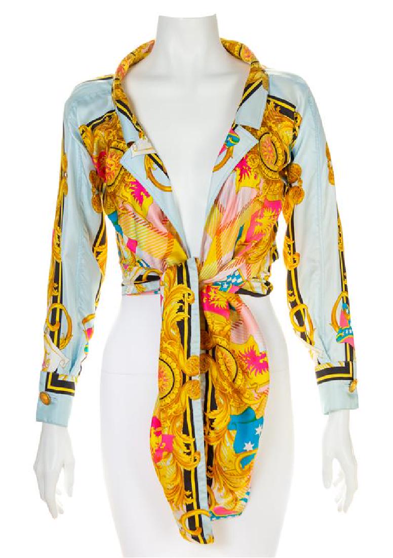 A Gianni Versace Silk Print Tie Front Blouse, Size 38.: A Gianni Versace Silk Print Tie Front Blouse, Spring/Summer 1993, "Flags" print with a notched collar, an open front with a tie closure at the waist and decorative goldtone and Medusa buttons at the c
