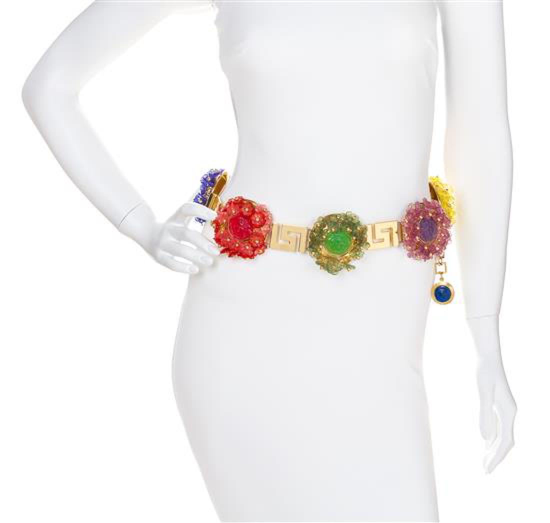 A Gianni Versace Multicolor Floral and Greco Link Belt,: A Gianni Versace Multicolor Floral and Greco Link Belt, Spring/Summer 1993, goldtone with six single color resin flowers and embossed Medusa medallion discs and an adjustable hook closure. Design feat