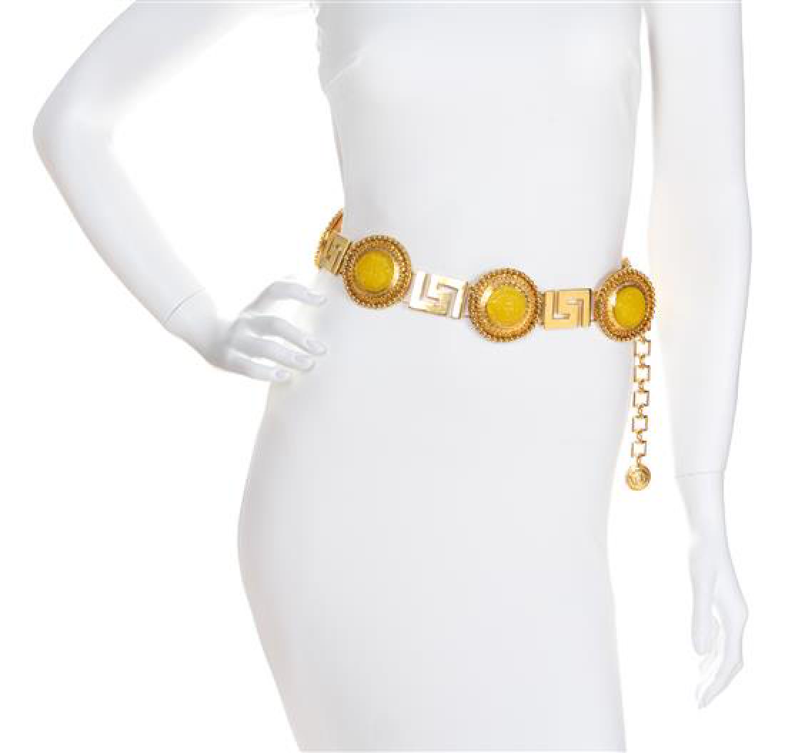A Gianni Versace Yellow Medallion and Greco Link Belt,: A Gianni Versace Yellow Medallion and Greco Link Belt, Spring/Summer 1993, goldtone with embossed Medusa medallions and an adjustable hook closure with a Medusa charm embellishment. Design featured in