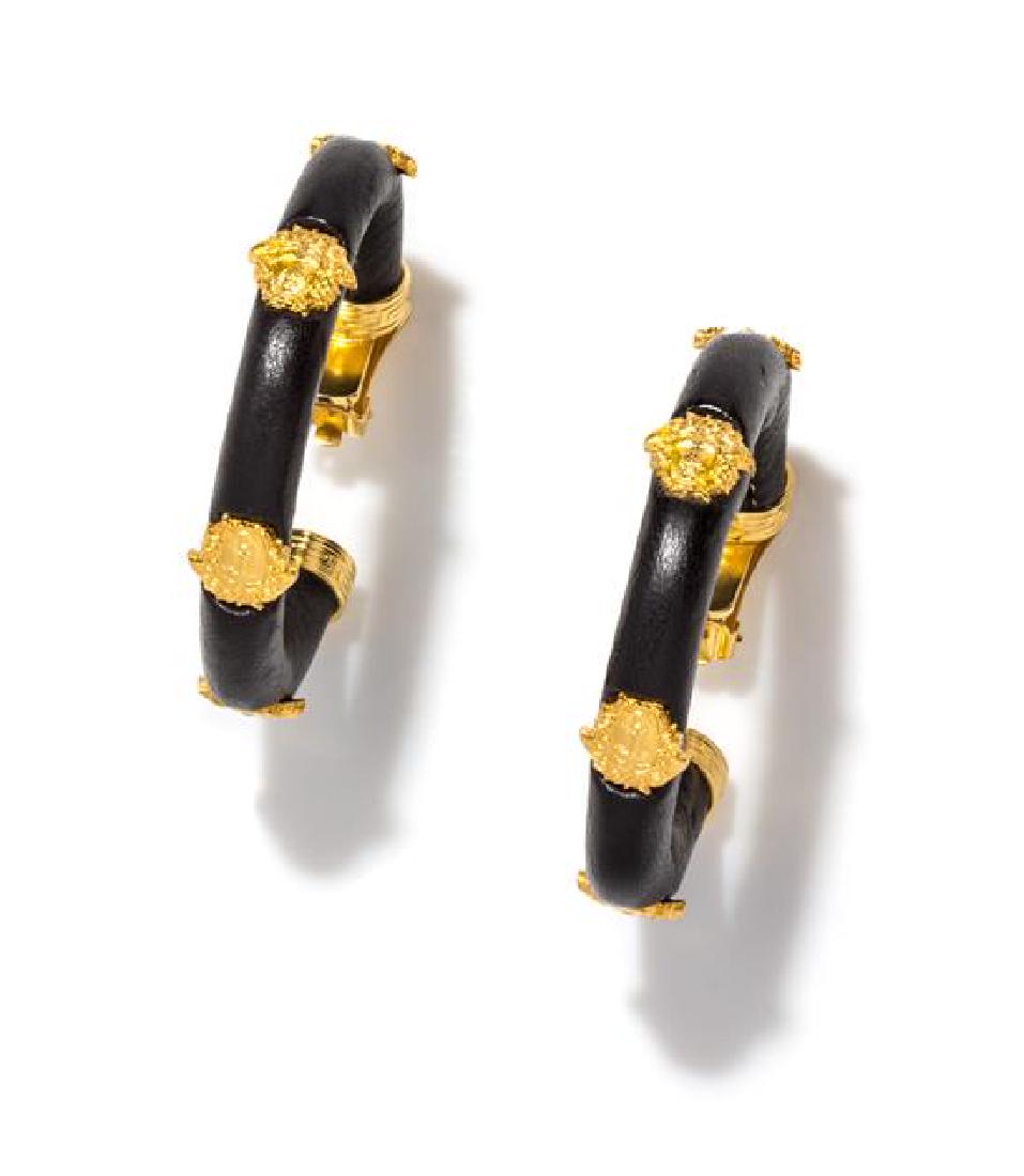 A Pair of Gianni Versace Black Leather Earclips, 4.25": A Pair of Gianni Versace Black Leather Earclips, Autumn/Winter 1992-1993, with goldtone decorative Medusas. Design featured on the Fall 1992 Milan runway (Look 40). Stamped: Gianni Versace. 4.25" diam