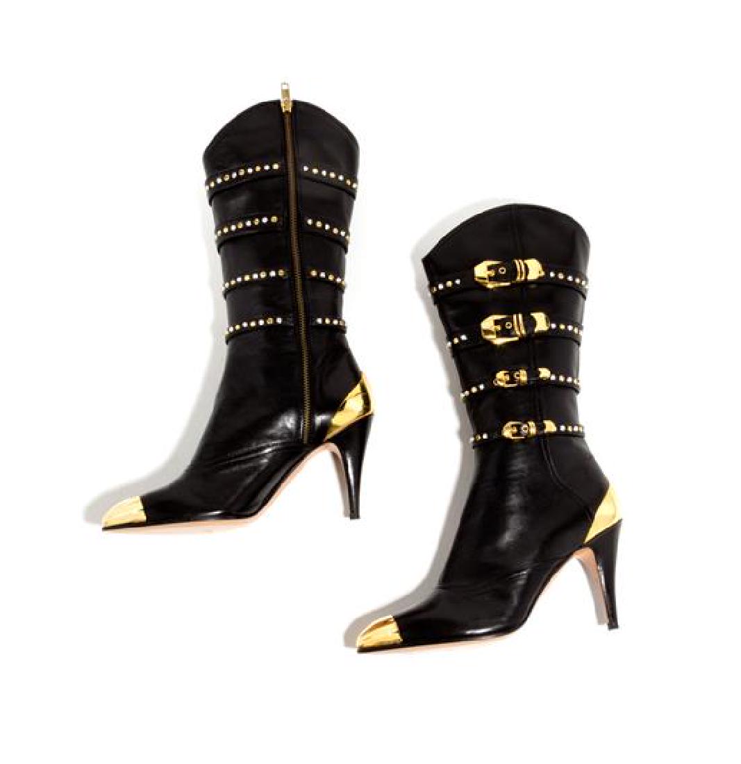 A Pair of Gianni Versace Black Leather and Gold Tip: A Pair of Gianni Versace Black Leather and Gold Tip Boots, 1990s, with black leather belt embellishment with decorative rhinestone and goldtone grommets, buckles and a side zip closure. Together with