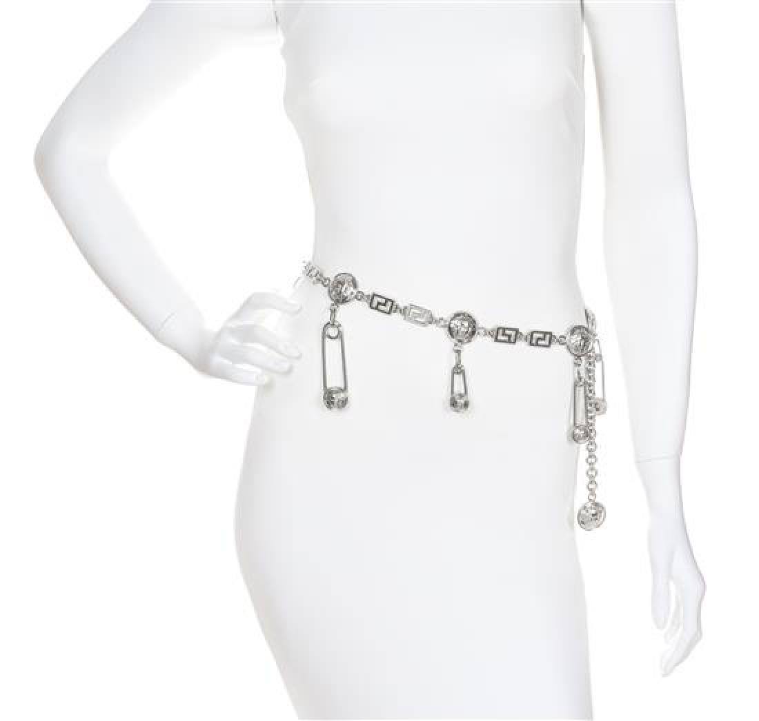 A Gianni Versace Safety Pin and Greco Link Belt,: A Gianni Versace Safety Pin and Greco Link Belt, Spring/Summer 1994, silvertone with Medusa embossed medallion discs and an adjustable hook closure. Unstamped and attributed to: Gianni Versace. Estima