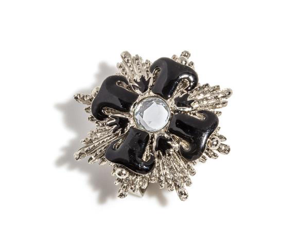 A Gianni Versace Black and Silvertone Belt Slide,: A Gianni Versace Black and Silvertone Belt Slide, 1990s, with a large center rhinestone. Unstamped and attributed to: Gianni Versace. Estimate $200-300 Property from a Single-Owner Collector of 90s Gi