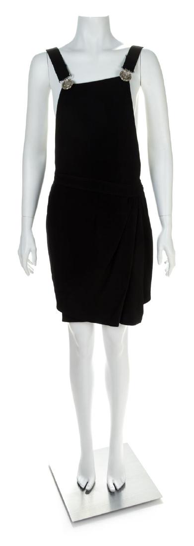 A Gianni Versace Black Wool Suspender Mini Dress, No: A Gianni Versace Black Wool Suspender Mini Dress, Autumn/Winter 1993-1994, with a bib front, topstitched shoulder straps with decorative silvertoned Medusa embossed suspenders, a fitted waist with a d