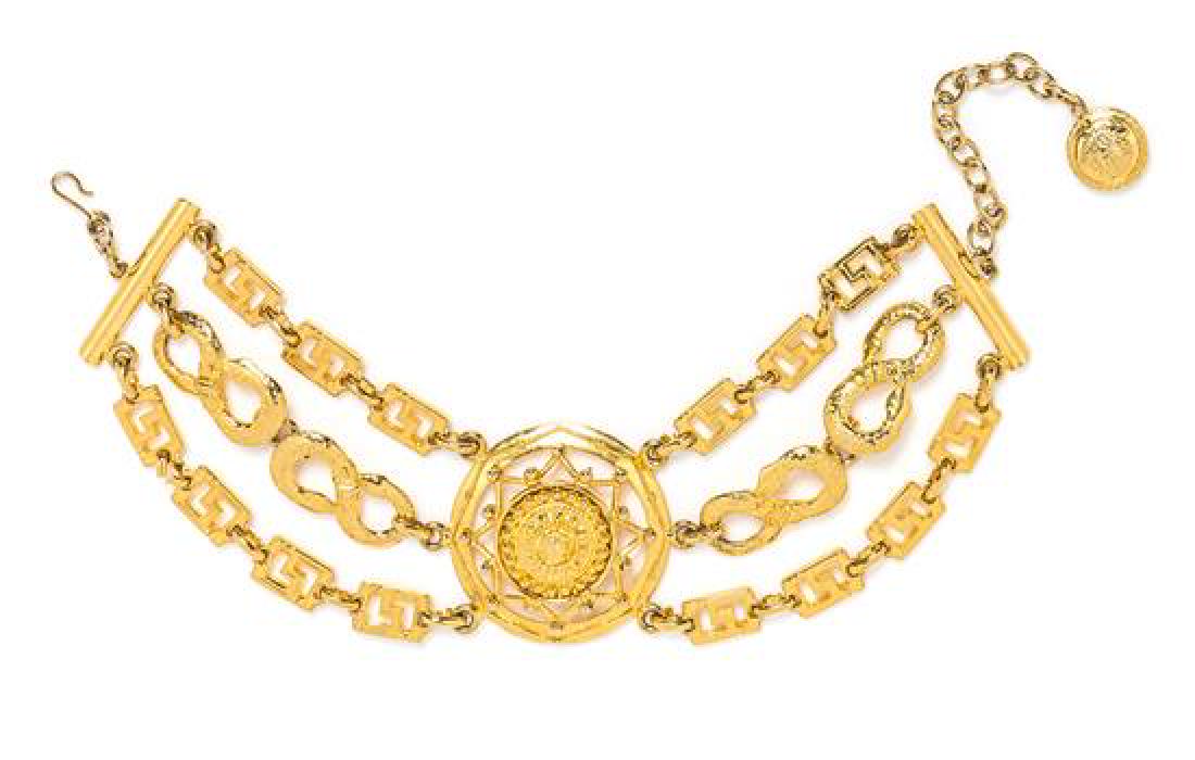 A Gianni Versace Triple Strand Choker with Center: A Gianni Versace Triple Strand Choker with Center Medallion, 1990s, goldtone with two strands of greco links and one strand of coiled snakes, a center medallion with a star and embossed Medusa and an