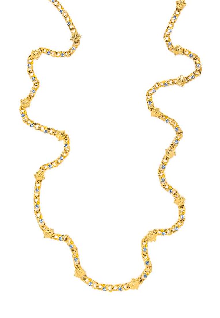 A Gianni Versace Blue Rhinestone and Medusa Link: A Gianni Versace Blue Rhinestone and Medusa Link Necklace, 1990s, goldtone with a lobster clasp. Stamped: Gianni Versace. Length: 45.25". Estimate $300-400 Property from a Single-Owner Collector of 90