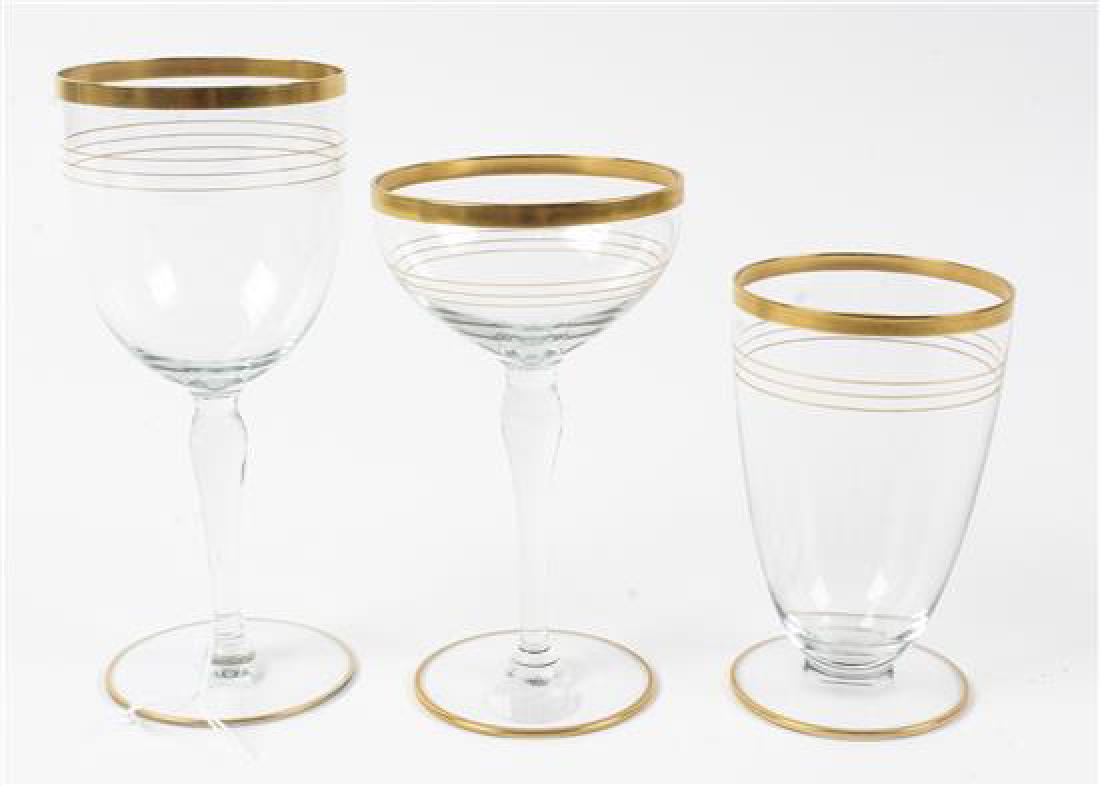 A Gilt Decorated Glass Stemware Service: * A Gilt Decorated Glass Stemware Service 20th century comprising: 12 water goblets 10 champagne coupes 11 wine glasses in total 33 items Height of wine 5 inches. Estimate $300-500 Property