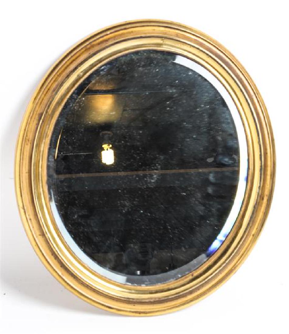An Oval Gilt Metal Mirror: An Oval Gilt Metal Mirror Height 15 x width 13 inches. Estimate $50-70