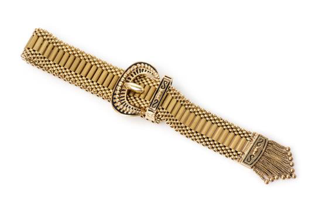 A 14 Karat Yellow Gold and Enamel Belt Bracelet, Succo,: A 14 Karat Yellow Gold and Enamel Belt Bracelet, Succo, composed of a tubular link bracelet, the terminal accented with black enamel and a chain tassel fringe, the size adjustable with the buckle moti