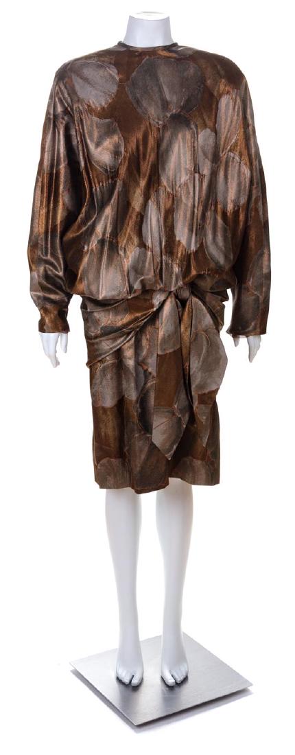 * A Ruben Panis Brown Metallic Cocktail Dress, No size.: * A Ruben Panis Brown Metallic Cocktail Dress, with a round neckline, bat wing sleeves, a dropped waist with a decorative bow and back snap closure. Labeled: Ruben Panis. No size. Estimate $150-250 Ov