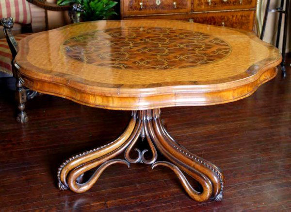 A rare Austrian Aesthetic Movement rosewood, satin: A rare Austrian Aesthetic Movement rosewood, satinwood, ebony, walnut and mahogany center table attributed to Michael Thonet the shaped circular tilt-top veneered with a parquetry design, raised on an