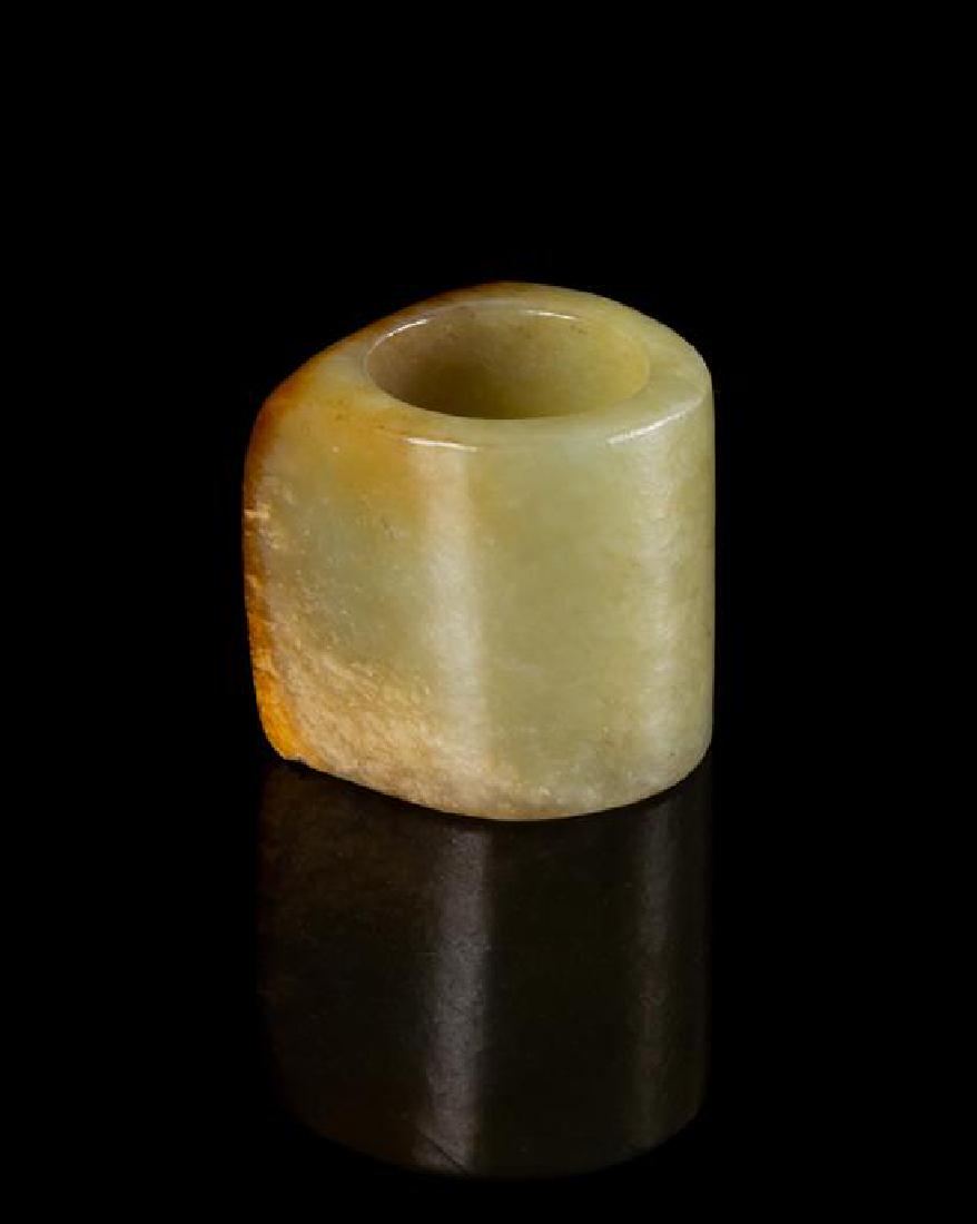 A Celadon and Russet Jade Archer's Ring Length 1 1/8 (1 of 2)