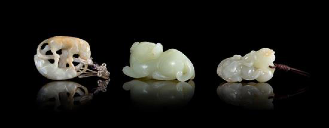 Three Celadon Jade Figures of Animals Length of largest: Three Celadon Jade Figures of Animals the first showing a fu lion playing with a brocade ball, the second a recumbent mythical beast, the third double badgers. Length of largest 2 3/4 inches. Estimate