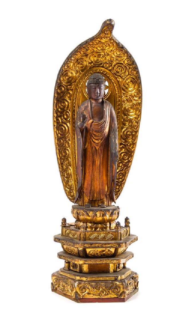* A Japanese Lacquer Traveling Shrine Height of shrine: * A Japanese Lacquer Traveling Shrine 18th/19th century of rectangular form, having a pair of pull-out doors, opening to show a standing Buddha atop a stepped throne, the right hand raised and the lef