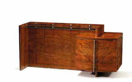 GILBERT ROHDE, (AMERICAN 1894-1944), Desk: GILBERT ROHDE (AMERICAN 1894-1944) Desk For Herman Miller, rosewood, walnut, glass and stainless steel, with manufacturer's label. H: 26, W: 56, D: 19 in.