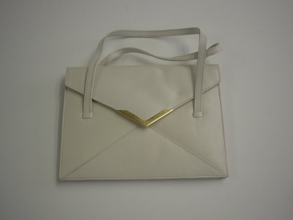 Two Guy LaRoche purses, 1960s, One envelope-shape: Two Guy LaRoche purses 1960s One envelope-shaped with two loop handles in eggshell calfskin and lined in soft kid, the other also flat with a flap-front with bow detail in off-white silk twill and lin