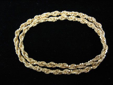 Yellow gold braided" necklace, , Long, 18 karat y: Yellow gold braided" necklace Long, 18 karat yellow gold braided necklace. Three longer chains have been woven to create the interesting braided necklace of two rope chains and one flat disc chain. Ci