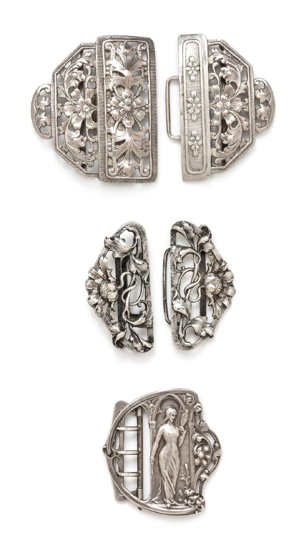 A Collection of Buckles, French and German: A Collection of Buckles, French and German, consisting of a buckle by Piel Freres consisting of an image of a maiden with flowing hair holding a distaff, measuring approximately 52.00 x 54.00 mm, an 8