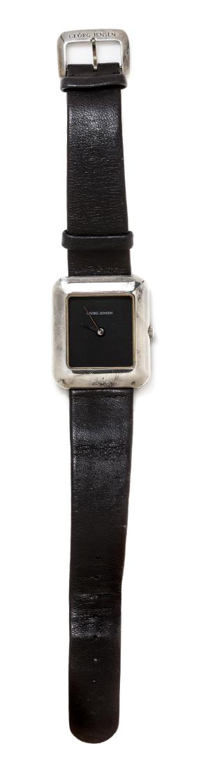 *A Sterling Silver Wristwatch, Lene Munthe for Georg: A Sterling Silver Wristwatch, Lene Munthe for Georg Jensen, 29.00 x 33.00 mm case dimensions, black dial signed GEORG JENSEN, silver pencil hands, snap on case back, quartz movement, black leather str
