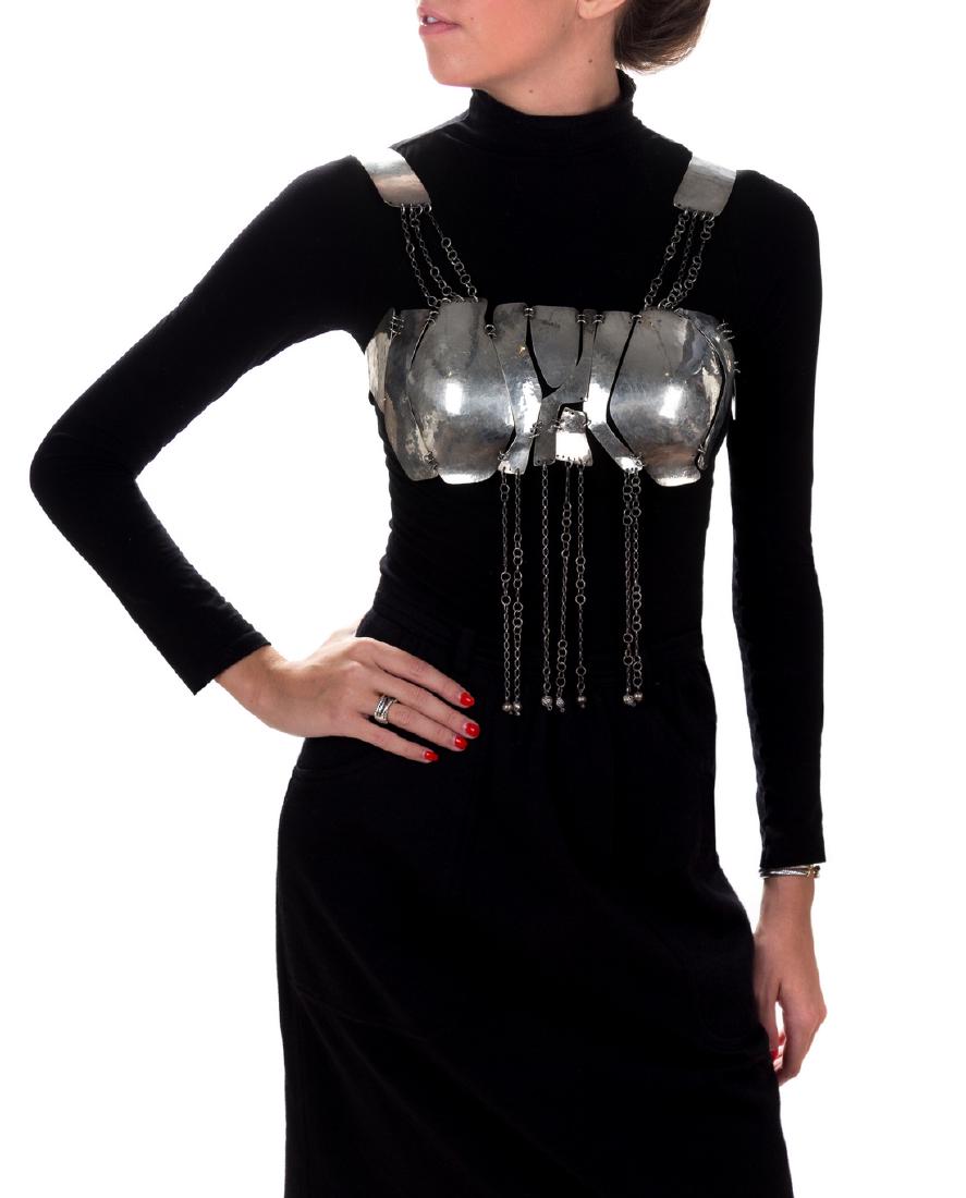 A Sterling Silver Bralette, Nancy Cohen: A Sterling Silver Bralette, Nancy Cohen, consisting of hammered silver shaped panels joined by jump rings and lengths of chain. Engraved: Nancy Cohen Sterling Silver. 319.20 dwts.