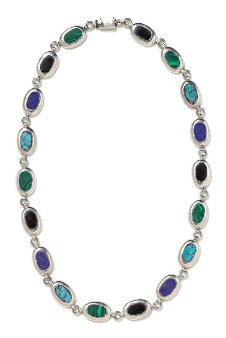 A Sterling Silver and Multigem Necklace, Taxco: A Sterling Silver and Multigem Necklace, Taxco, consisting of 18 oval links inlaid with onyx, malachite, turquoise and lapis lazuli buff top plaques. Stamp: TB-150 925. 28.80 dwts.