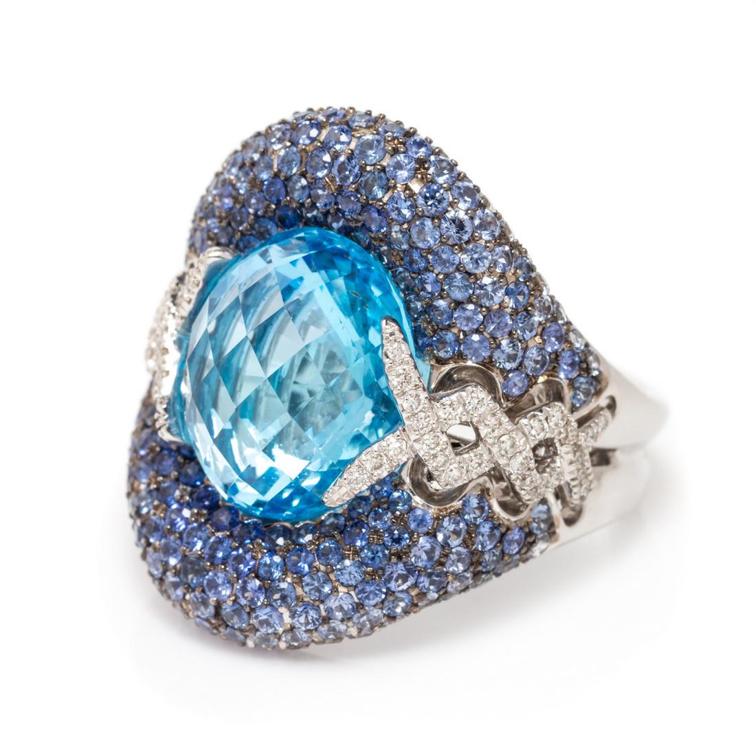 *An 18 Karat White Gold, Blue Topaz, Sapphire, and (1 of 2)