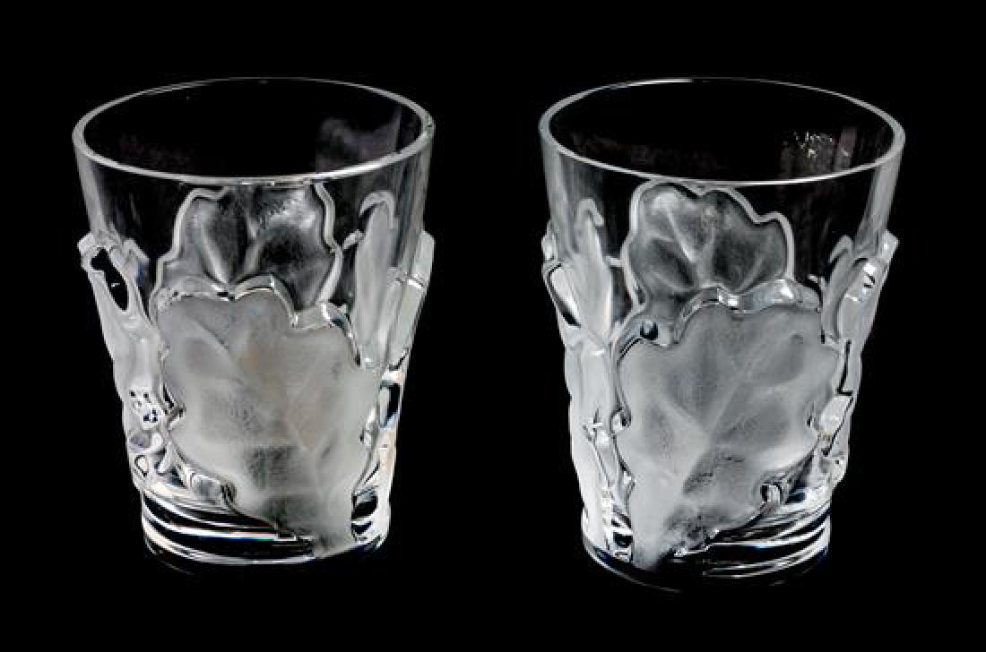 * A Pair of Lalique Molded and Frosted Glass Tumblers: * A Pair of Lalique Molded and Frosted Glass Tumblers with oak leaf decoration. Height 4 3/4 inches. Estimate $80-120 Property from the Estate of Ann and Lee Constable, Kansas City, Missour