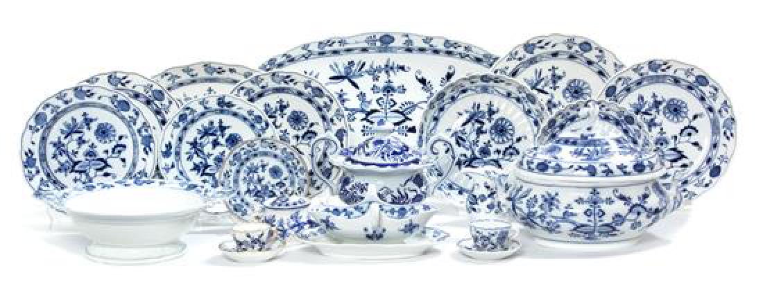 A Meissen Porcelain Dinner Service Length of largest 21: A Meissen Porcelain Dinner Service 19th/20th century in the Blue Onion pattern, some Meissen copies, comprising: 14 dinner plates 10 luncheon plates 6 bread and butter plates with gilt borders 6 soup 
