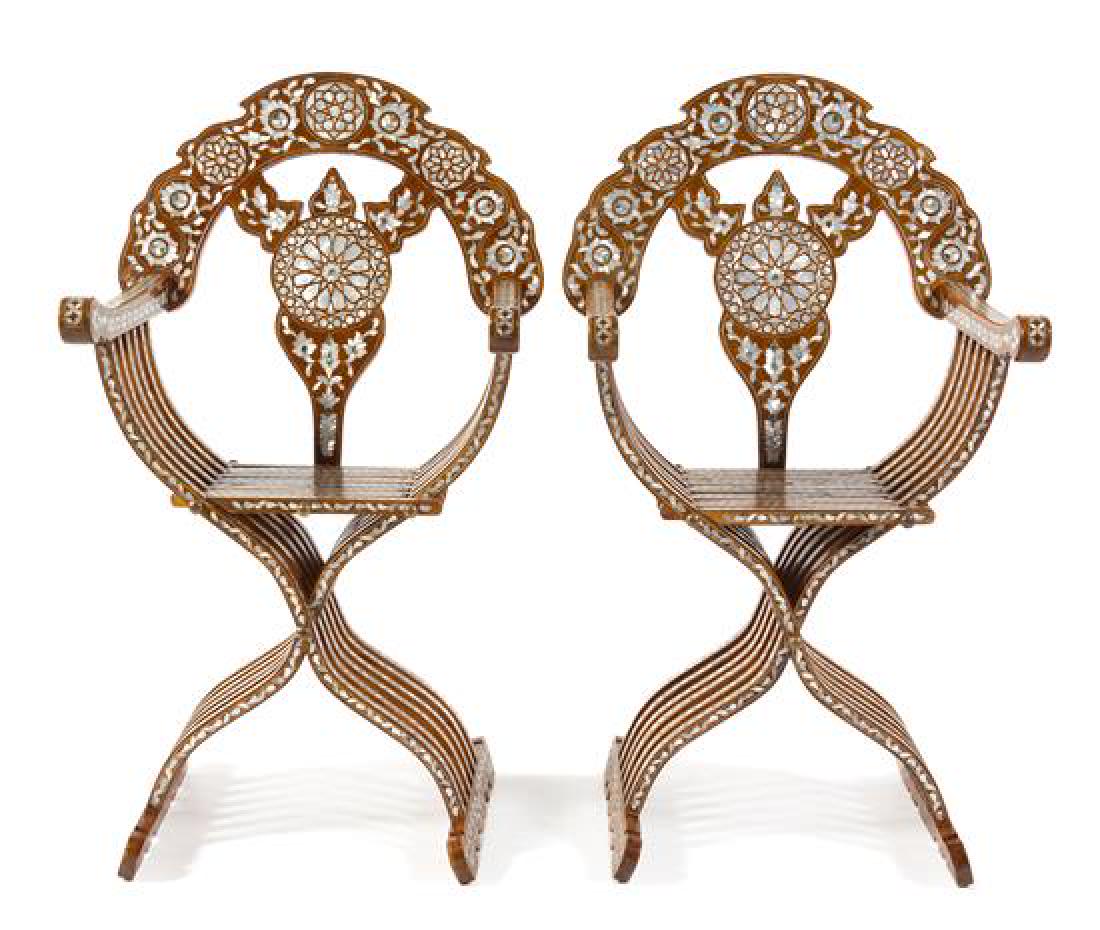 A Pair of Syrian Mother-of-Pearl Inlaid Savonarola: A Pair of Syrian Mother-of-Pearl Inlaid Savonarola Chairs 20th century each having a shaped crest rail and splat above the frame of typical form, heavily inlaid with geometric and foliate decoration. 
