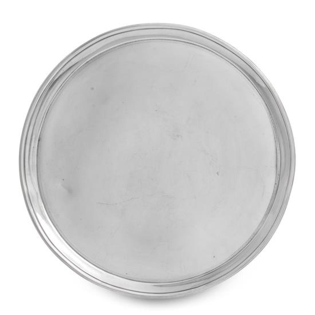 A George III Silver Salver, Robert Sharp, London, 1790,: A George III Silver Salver Robert Sharp, London, 1790 of circular form with a reeded rim, raised on three tapering feet worked to show volutes. marked for Sterling on underside 22 ozt 12 dwts Diameter