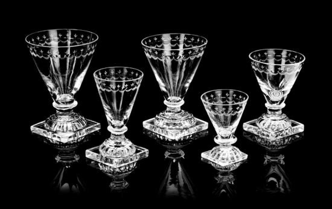 An English Cut Glass Stemware Service Height of tallest: An English Cut Glass Stemware Service early 19th century each having a Lemon Squeezer underside, the conical bowls with egg-and-dart decorated rims, comprising: 13 rummers, 11 water goblets, 12 red wi
